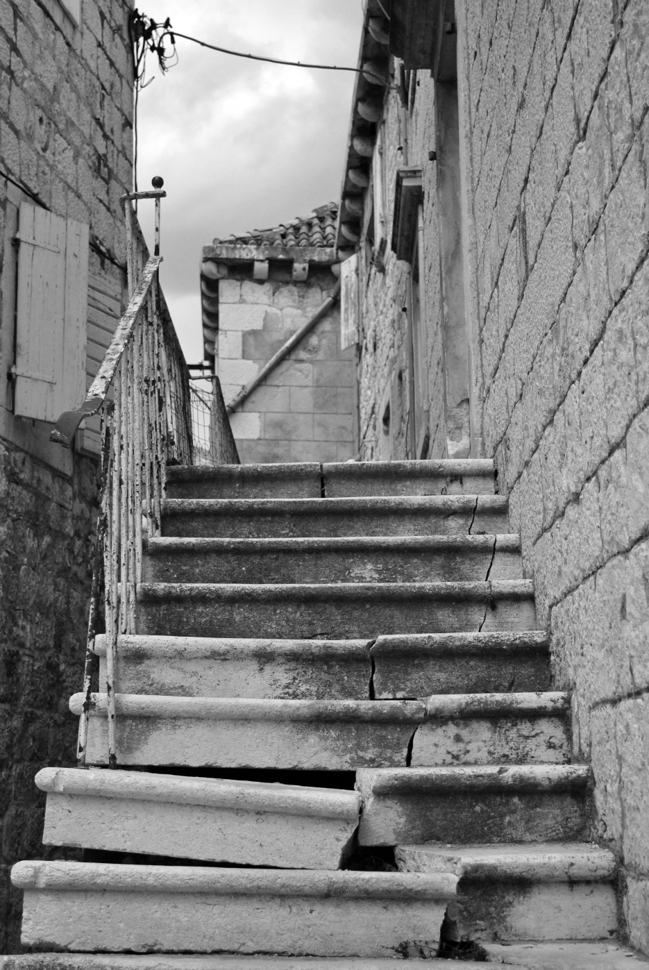 a set of stone stairs leading to two buildings