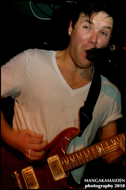 a young man that is playing a guitar