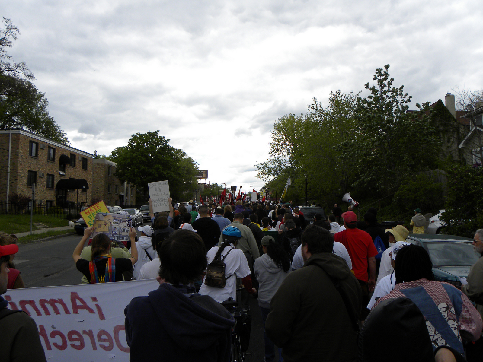 a group of people in the street are holding up signs