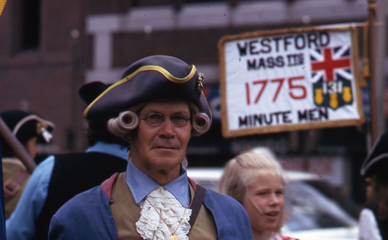 a man wearing a pirate costume standing next to some people