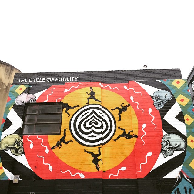 mural on the wall of a building depicts an image of the eye of human