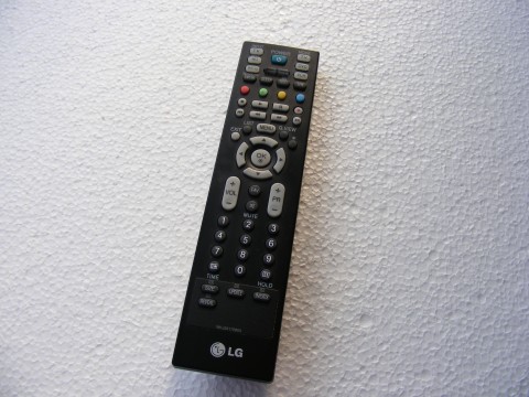 a black remote control sitting on the floor
