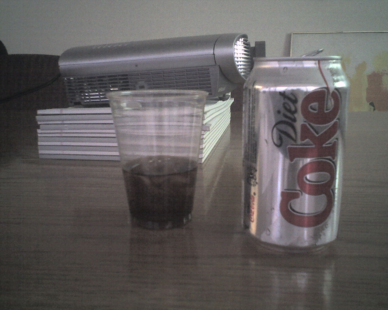 a cup with coke and a can of soda