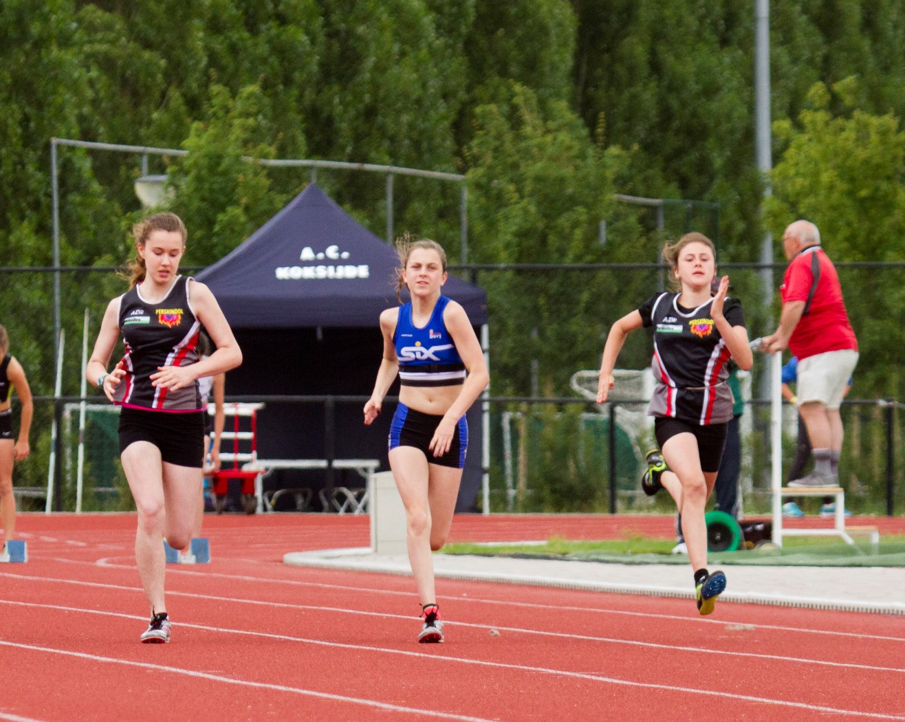 a group of women running on a track