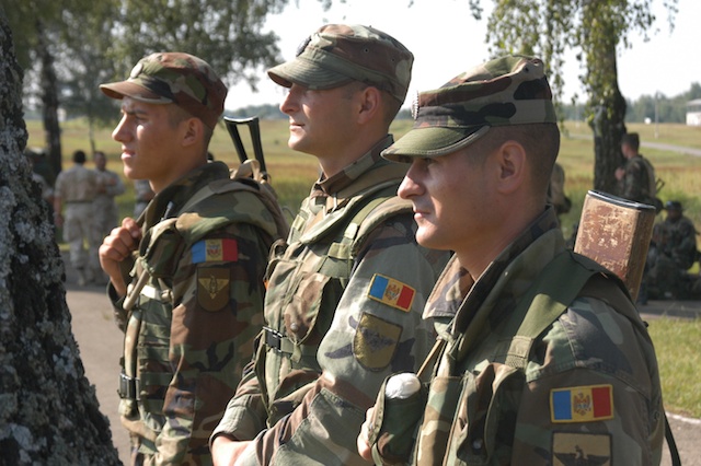 three soldiers are standing next to each other while in uniform