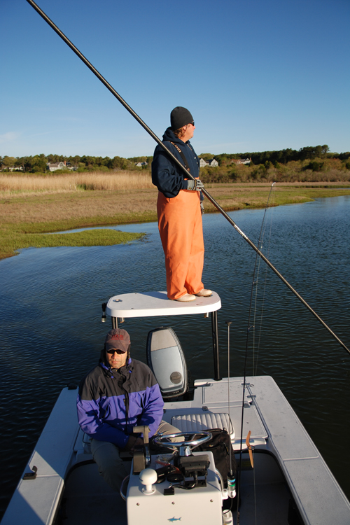 a person on a boat fishing with a fishing pole