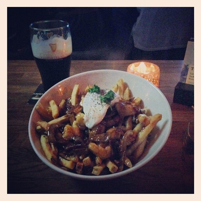 a close up of a bowl of food with french fries