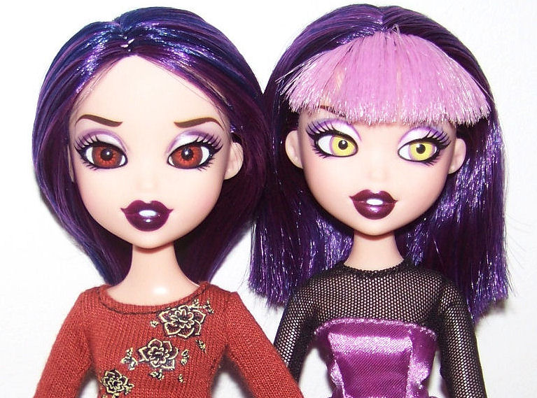 a couple of dolls are standing next to each other