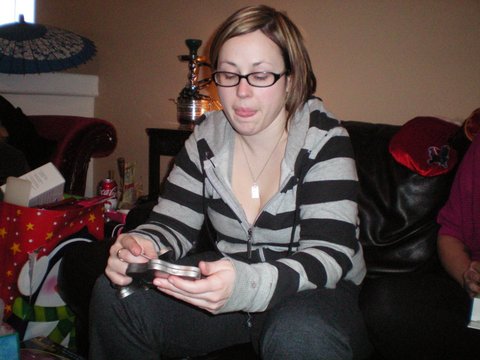 the woman sitting on the couch has a cellphone in her hand