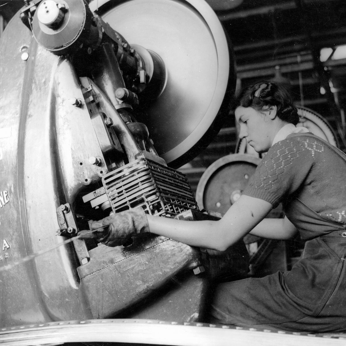 an old picture of a woman in an industrial plant