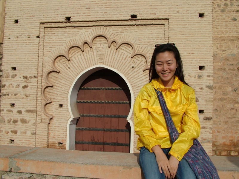 a woman in yellow is smiling for the camera