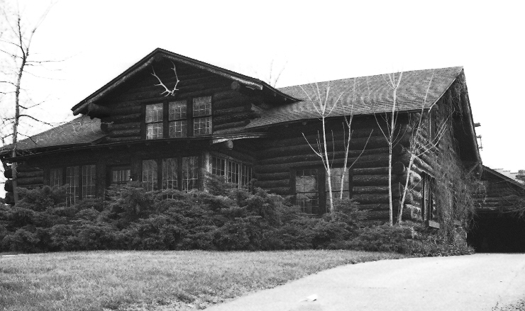 black and white pograph of an old log house