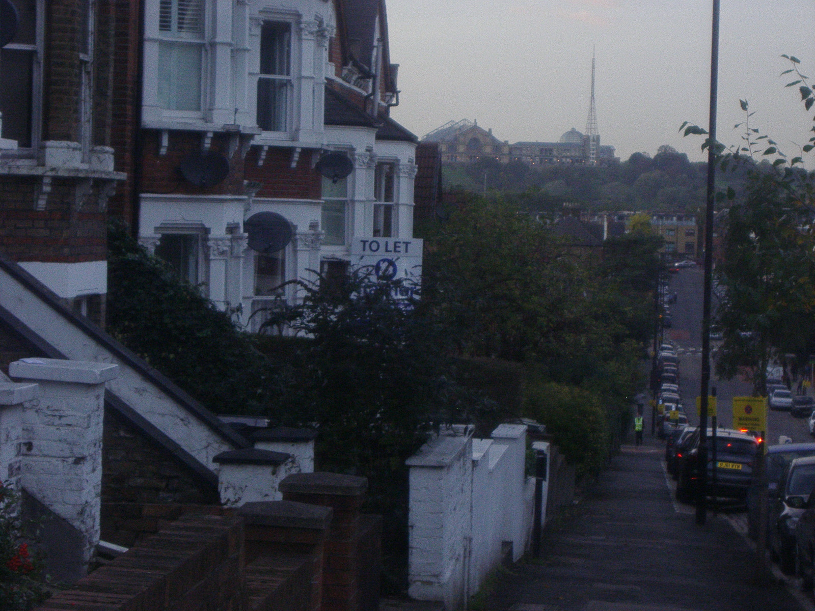 an overcast day and some buildings and a car on the street