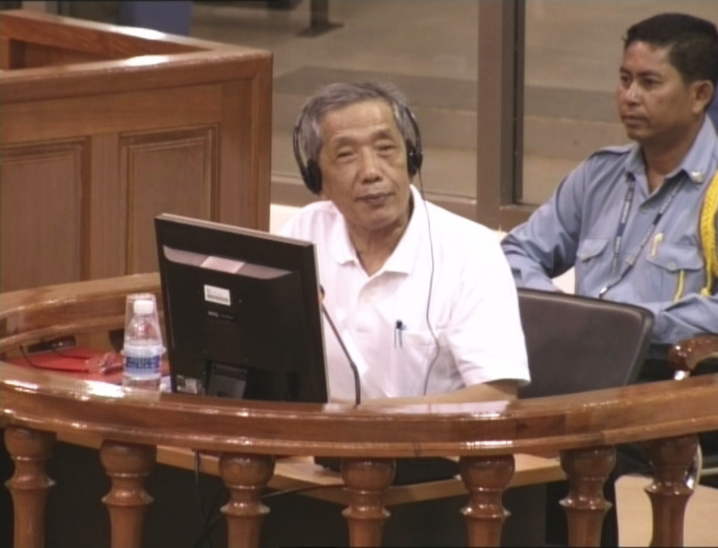 a man sits in front of his laptop while listening to the speakers