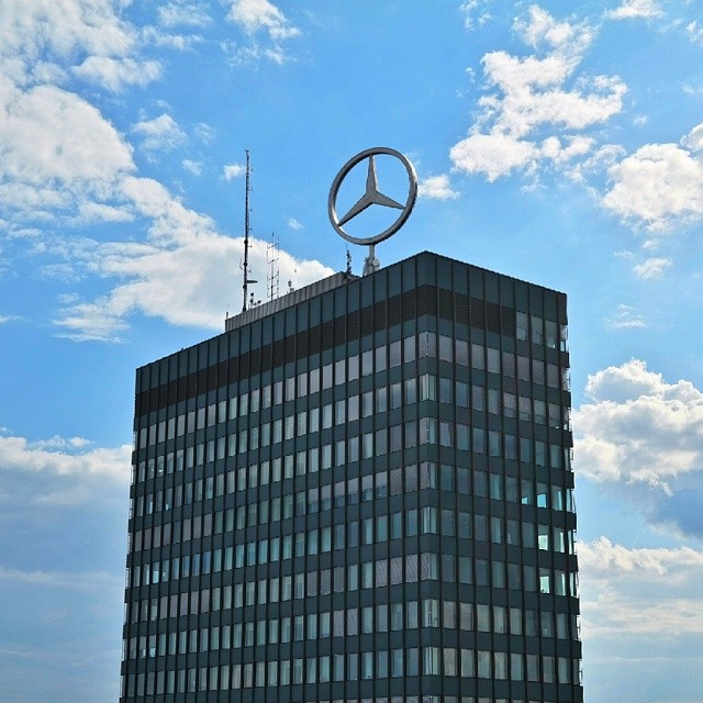 the mercedes building is shown on the top of it