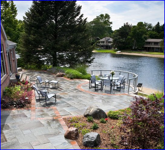 a stone patio near a large body of water