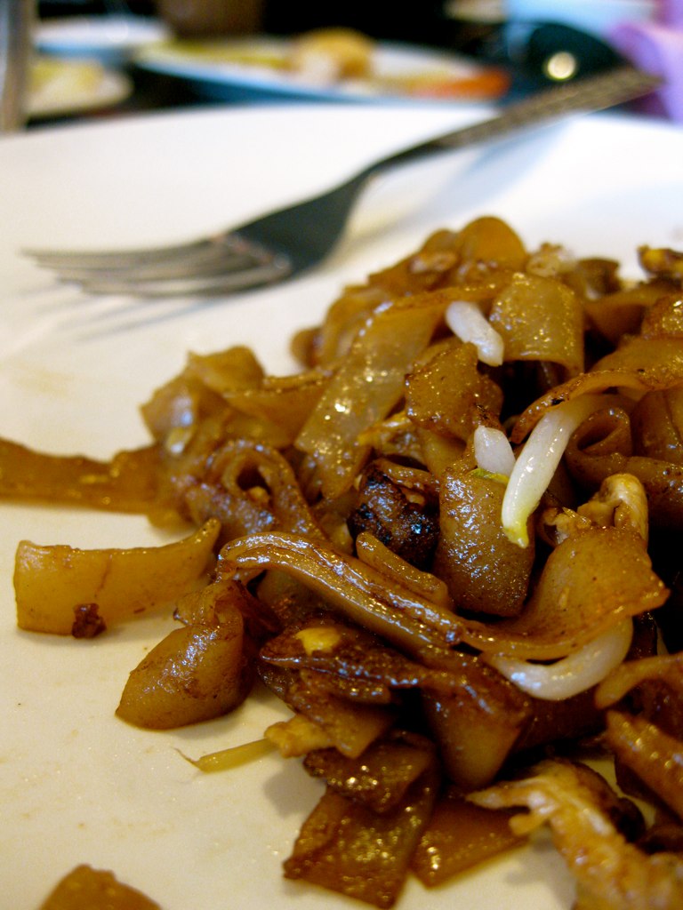 cooked food sits on a plate with a fork