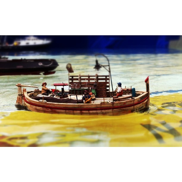 the small model boat is in the water