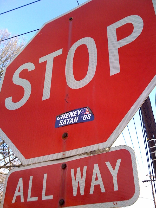 a stop sign that has a sticker on it