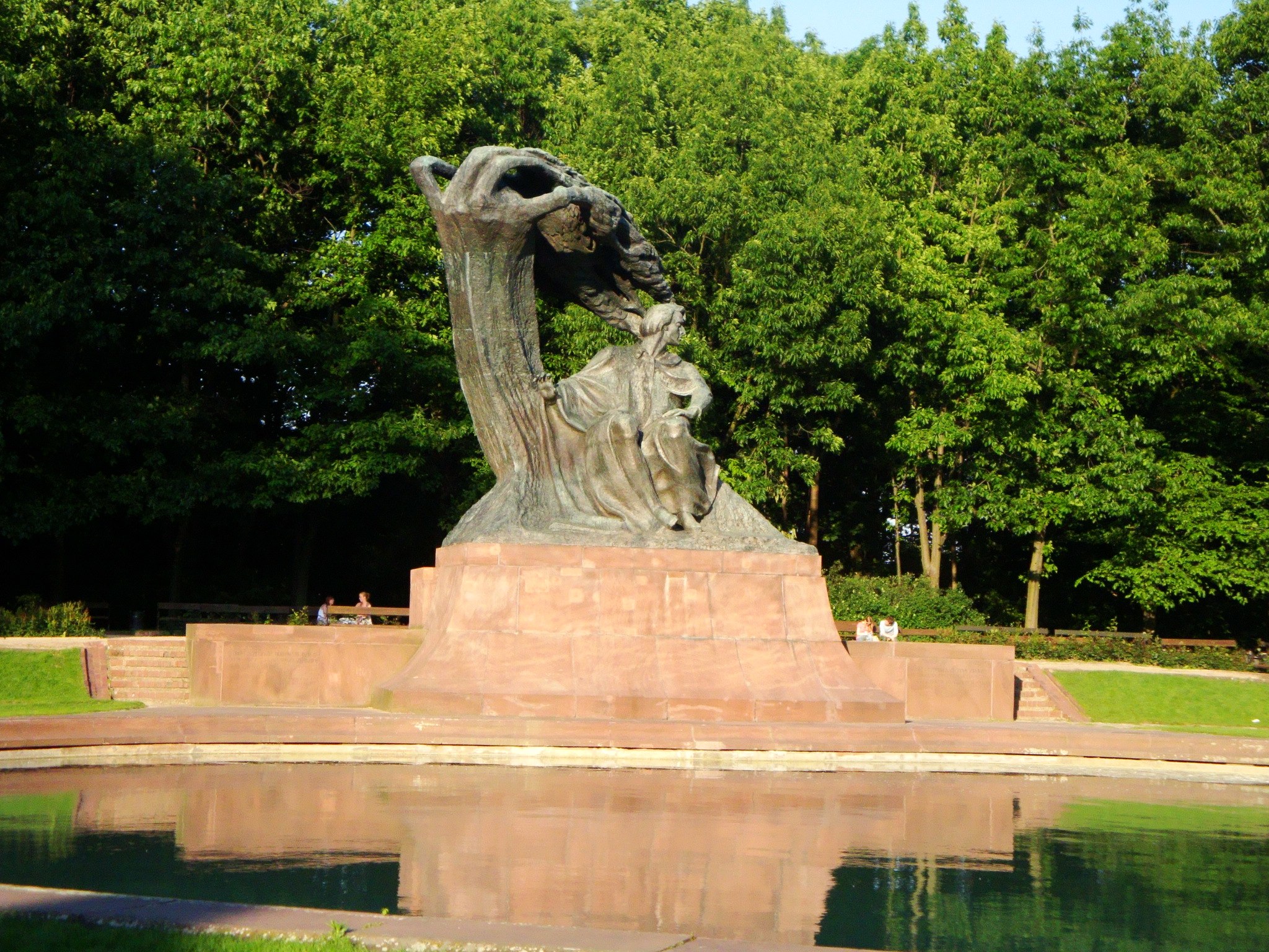 an interesting statue near the water features some large leaves