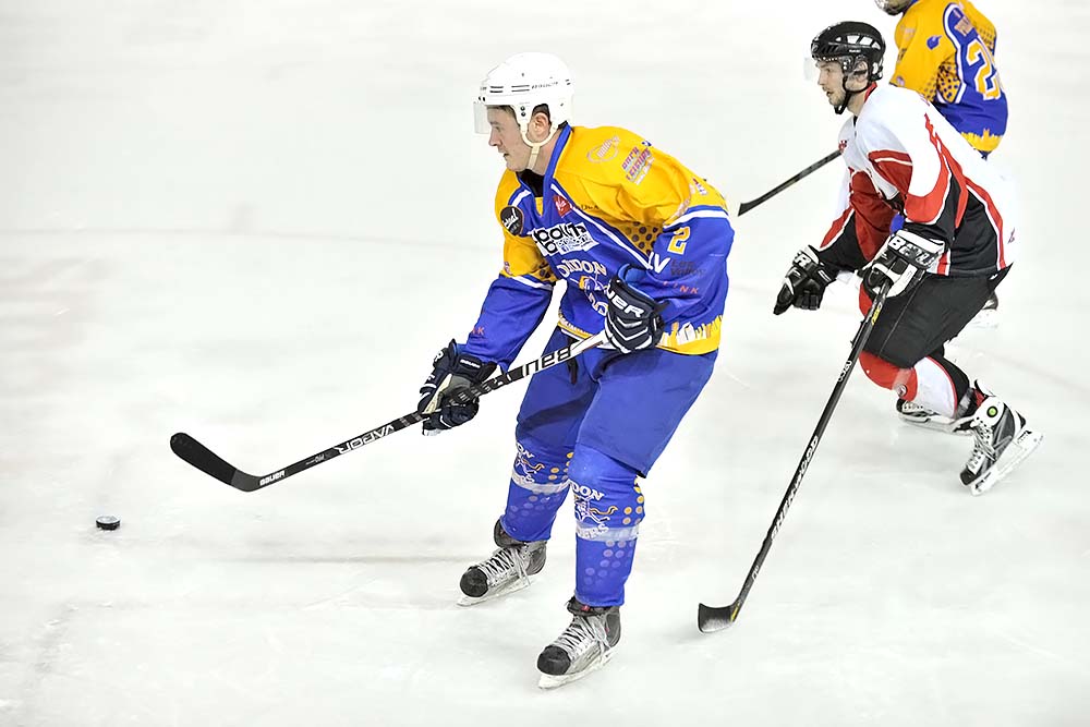 two players are playing ice hockey on the rink