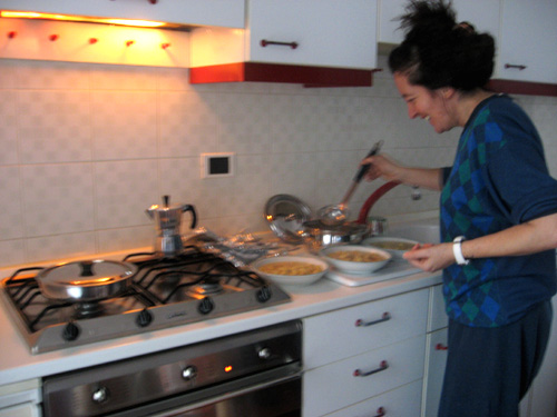 a woman is preparing food in the kitchen