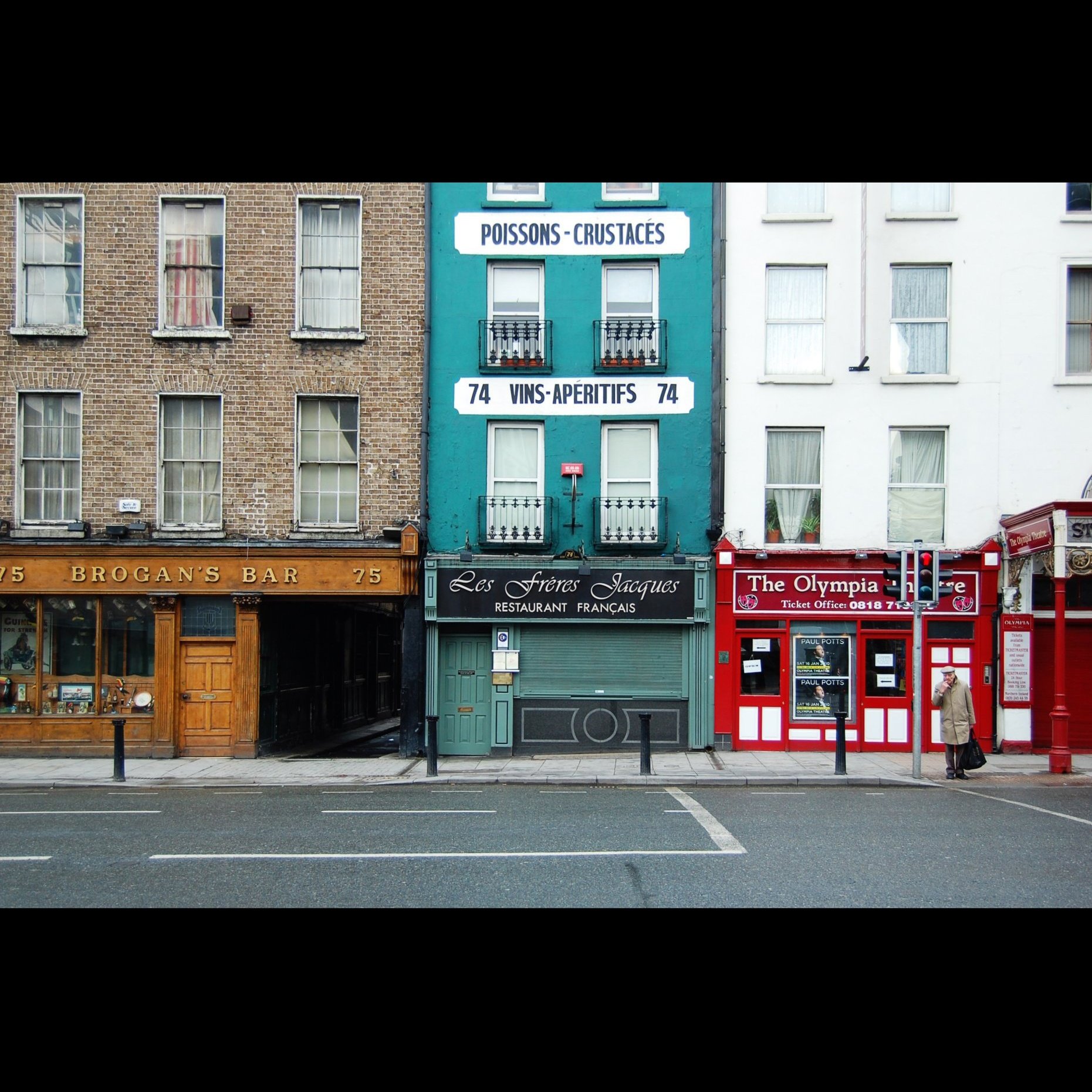 a street scene with focus on an old store