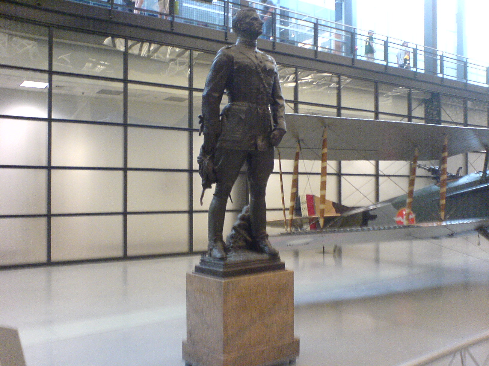 a bronze sculpture in the middle of an indoor museum