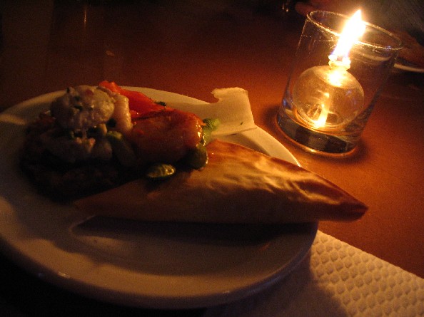 a dinner plate in front of a lit candle