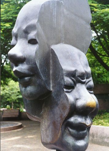 sculptures with various heads of people and faces