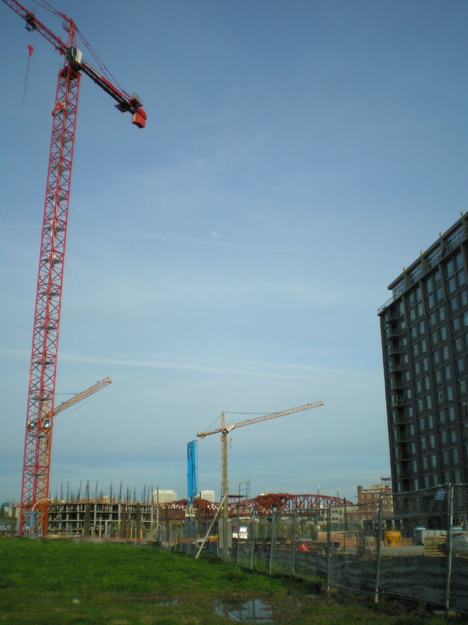 two large cranes next to a building under construction