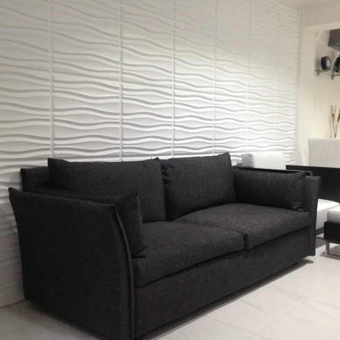 a black couch with white accents in a room