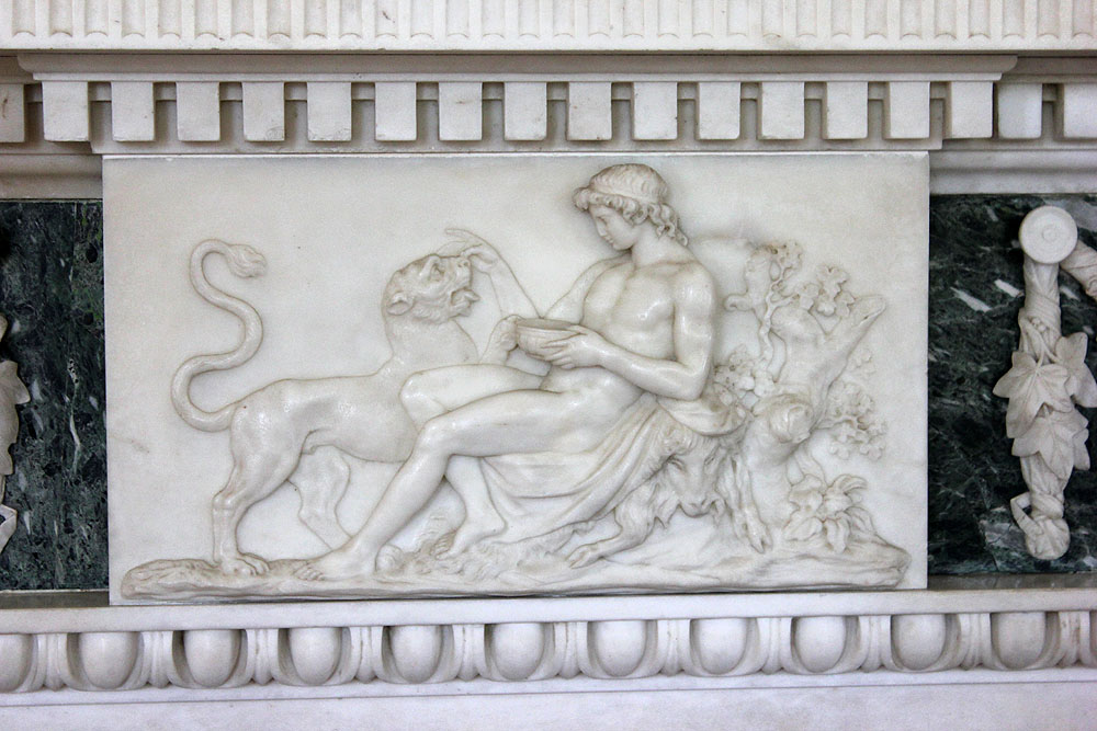 sculpture with man kneeling down and holding a cat