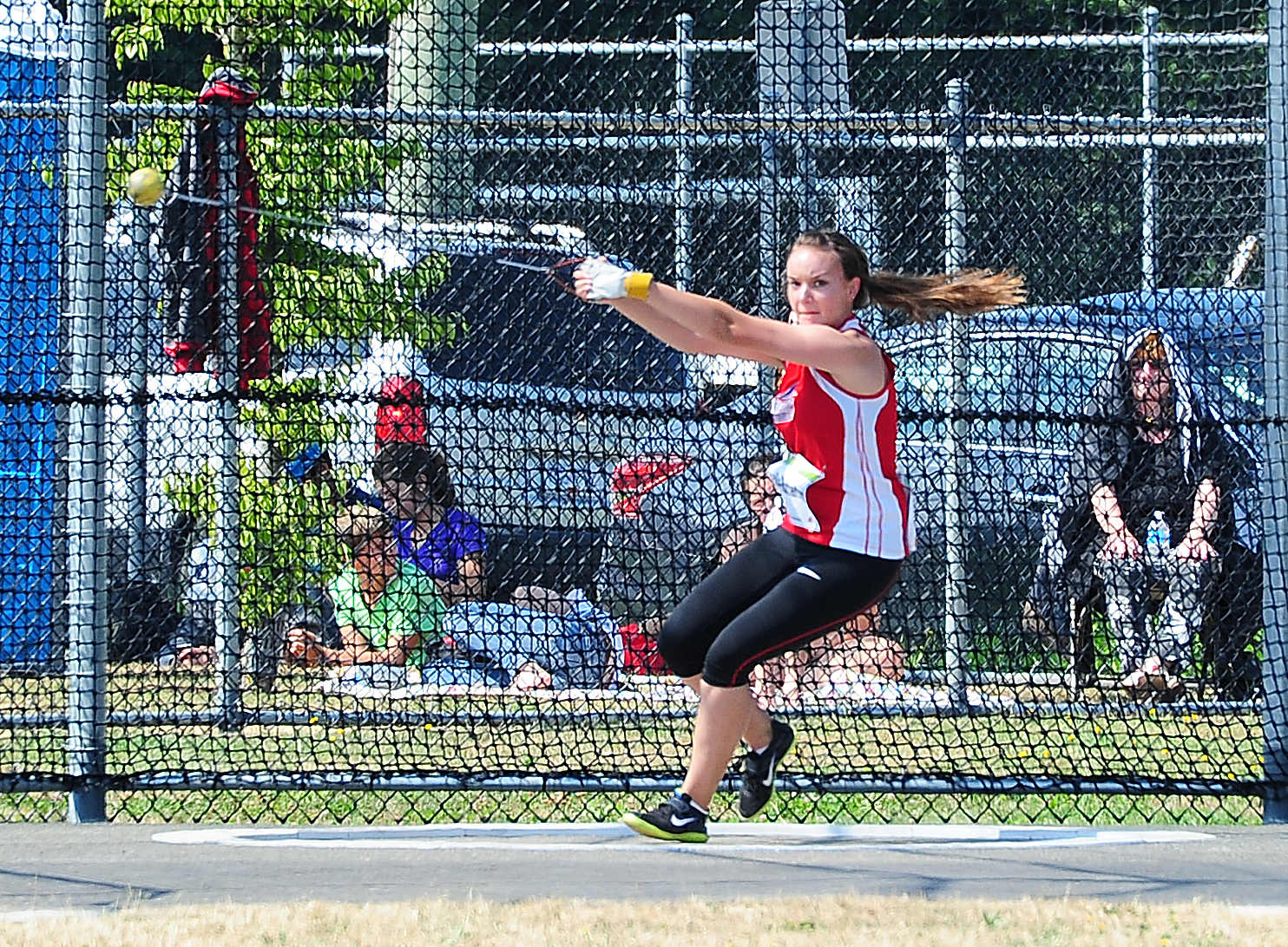 a woman swinging a tennis racquet on a tennis court