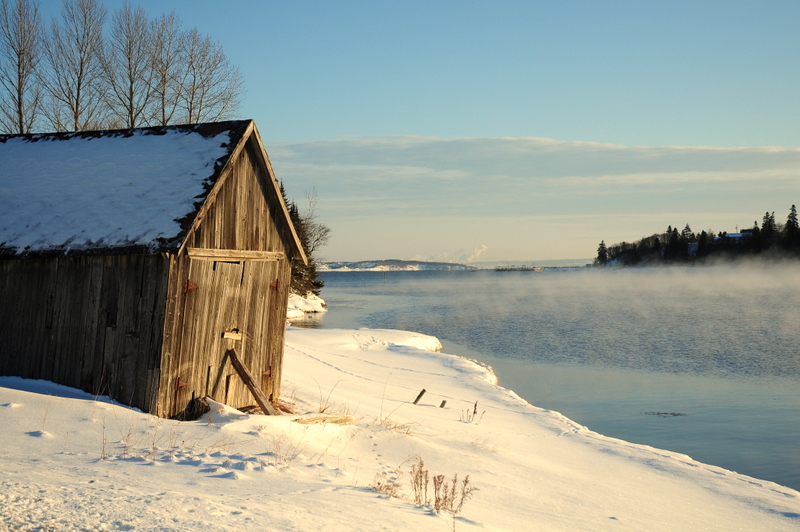 a snowy cabin sitting on top of a field