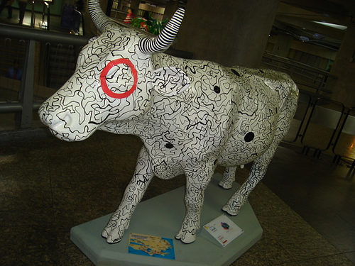 a bull statue in a museum like setting