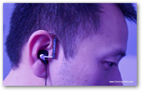 man listening to earphones in front of his head