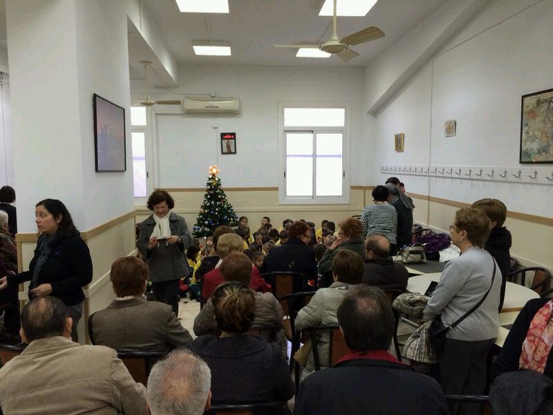 several people seated in rows and some people standing up with laptops