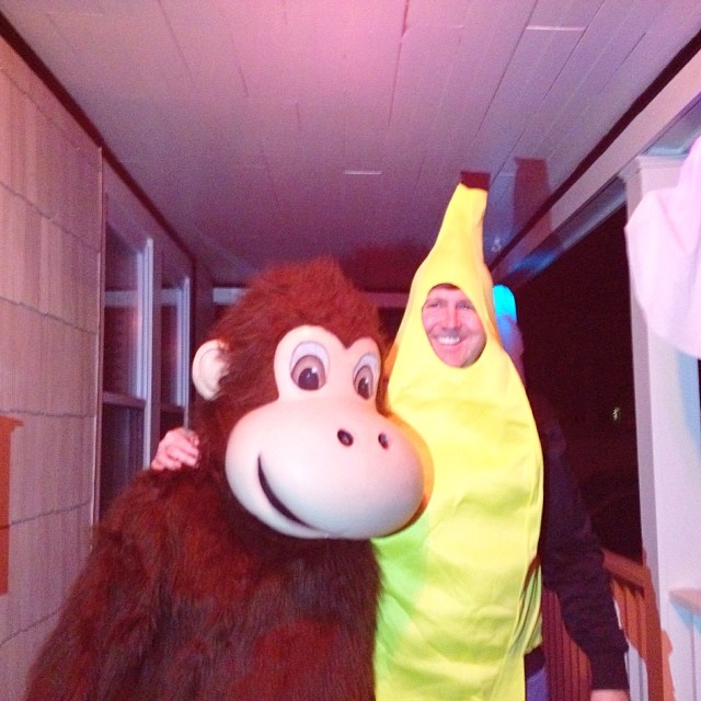 man with banana costume in hallway with monkey head
