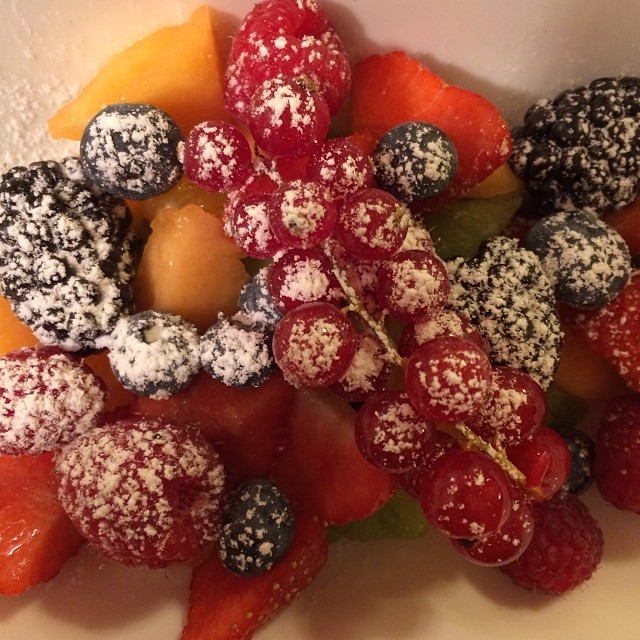 a white plate with various types of berries