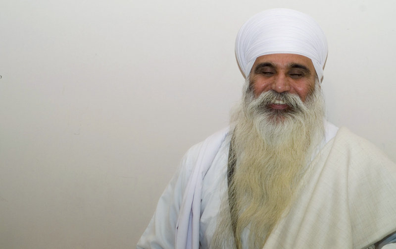 an elderly man wearing a white headdress and beard