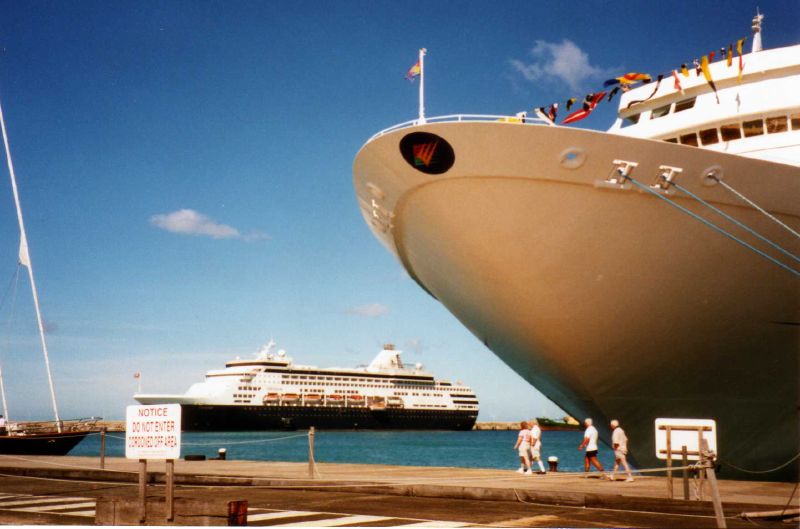 a large boat docked at the dock with a few people
