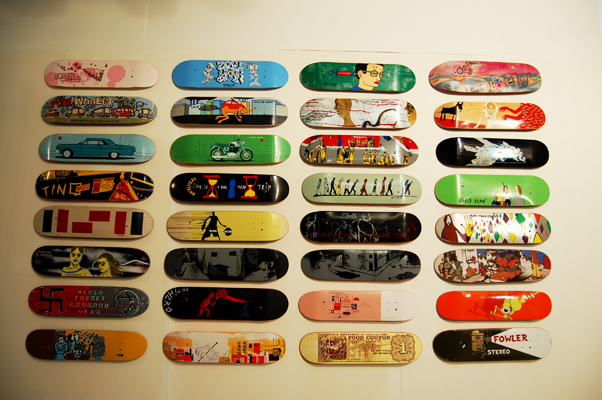the skateboards are hanging on the wall in a room