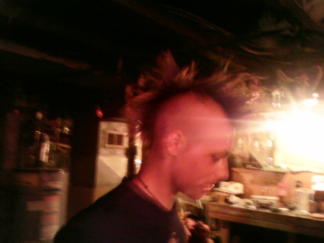 a man with his hair tied in a mohawk