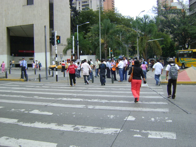 a lot of people crossing the street while walking