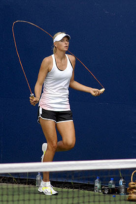 a woman is running and swinging a tennis racket on the court