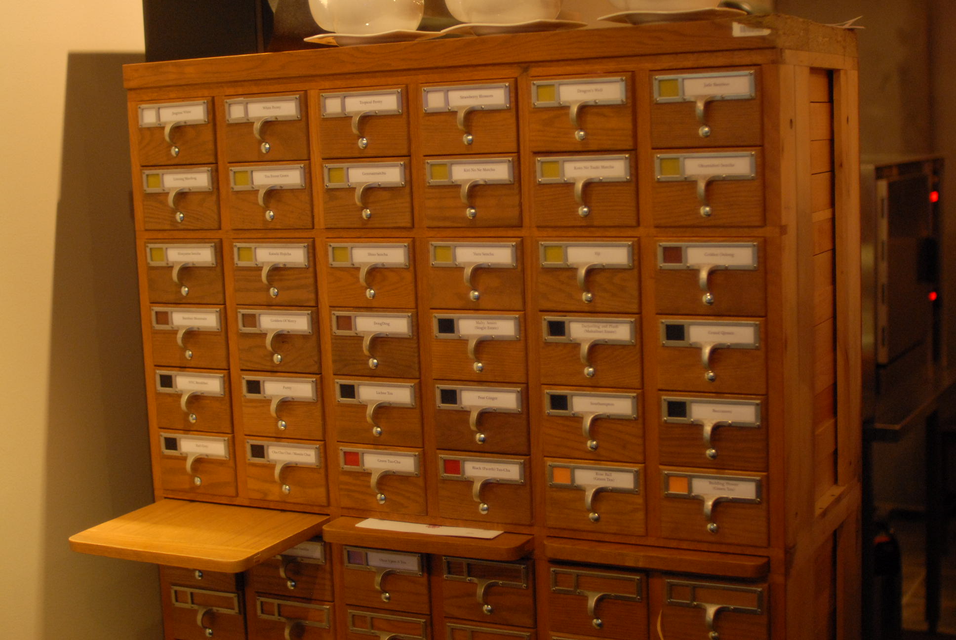 an assortment of mailboxes and boxes with numbered cards on top