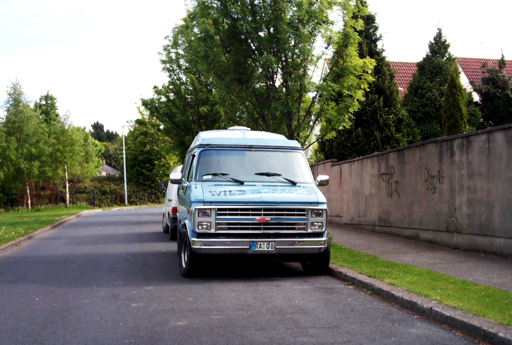 a van parked in front of a brick wall