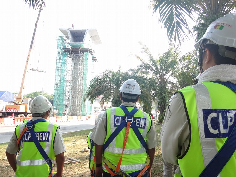 the four men are wearing safety vests