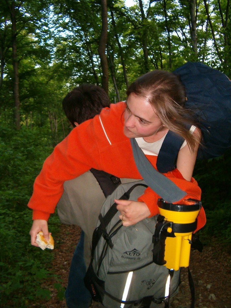 the girl has her back pack and a big backpack on